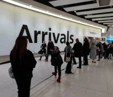 People waiting in the arrivals area of heathrow airport