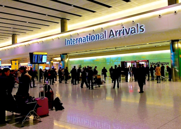 Moving to the UK - People waiting in the arrivals area of Heathrow airport