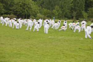 Group of children performing karate in a park