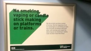 Sign on a train saying 'No smoking, vaping or candle stick making on platforms or trains'