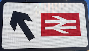 Road sign showing just the British Rail logo and an arrow 