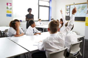 Children wearing school uniform in a classroom