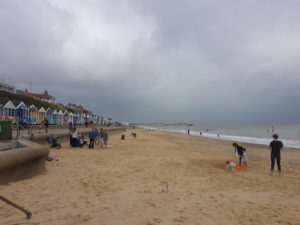 Beach in summer with heavy grey clouds covering the whole sky