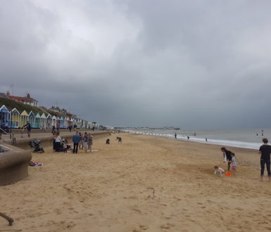 Beach in summer with heavy grey clouds covering the whole sky