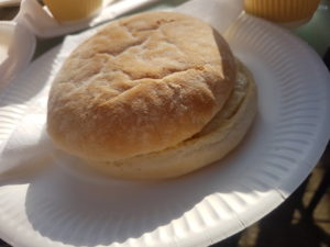 Picture of a flat wheat roll on a paper plate
