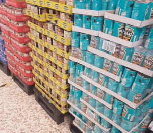 Pallets with tins of baked beans in a supermarket