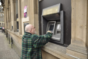 Man using cashpoint