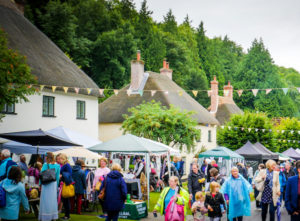 People visiting stalls of traditional village fayre