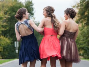Three young women in party dresses
